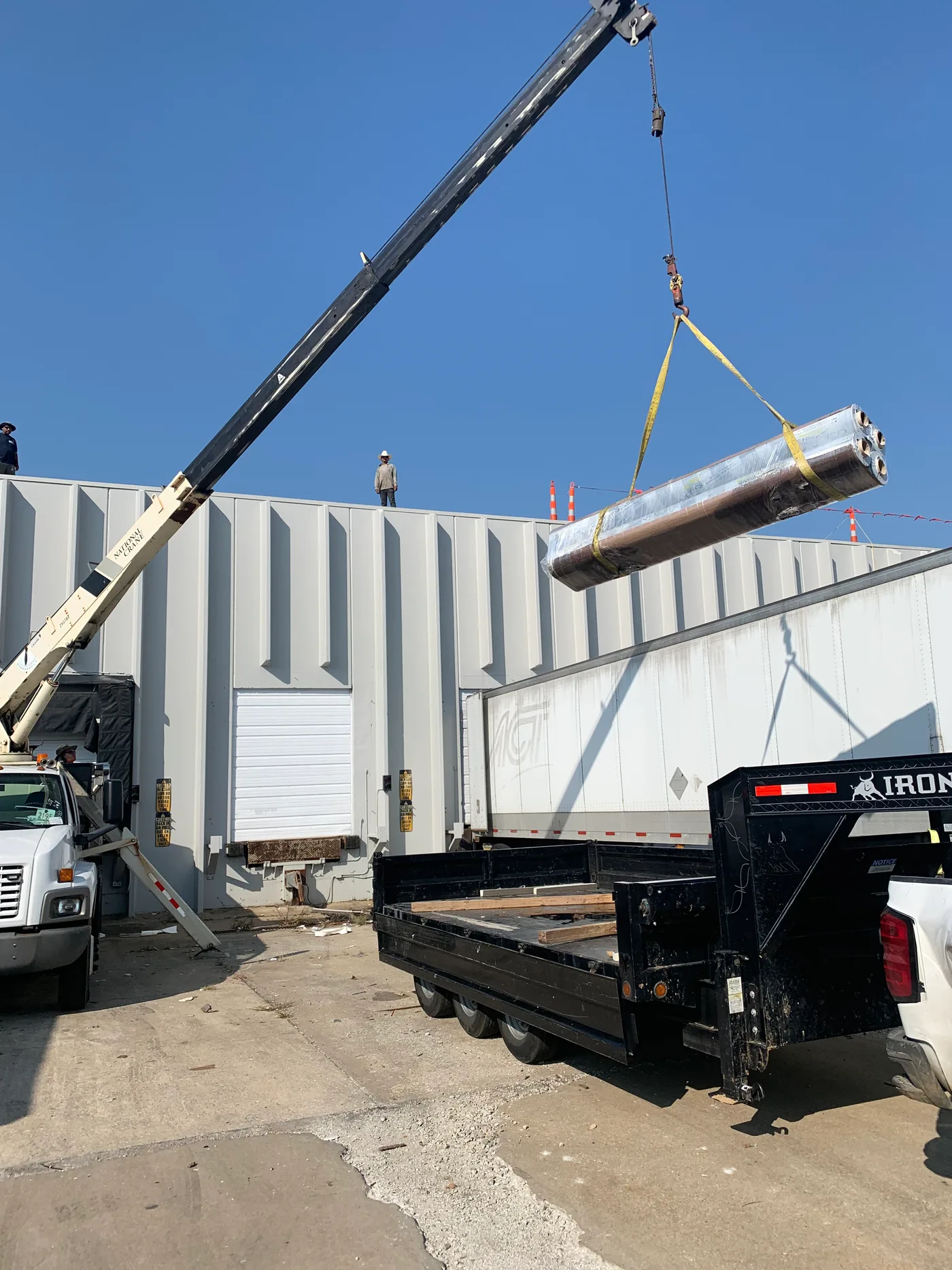 Commercial roofing materials being lifted to a roof